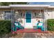 Inviting front porch featuring colorful decor, stone accents, and comfortable seating at 1148 Briarwood Ave, Deltona, FL 32725