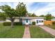 Charming single-story home with well-manicured lawn and inviting, colorful front porch decor at 1148 Briarwood Ave, Deltona, FL 32725