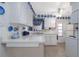 Bright kitchen with clean white cabinets, complemented by blue decorative accents at 1148 Briarwood Ave, Deltona, FL 32725