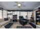Comfortable sunroom with an assortment of seating options, a ceiling fan, and dark accents at 1148 Briarwood Ave, Deltona, FL 32725