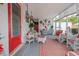 Cozy sunroom with white wicker furniture, red and white decor, lots of natural light and outdoor views at 1148 Briarwood Ave, Deltona, FL 32725