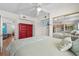 Bright bedroom featuring mirrored closet doors, queen bed, and a colorful red dresser at 1167 Ocean Shore Blvd # 110, Ormond Beach, FL 32176