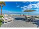 Outdoor deck with seating and ocean views; an ideal relaxation and entertaining space at 1167 Ocean Shore Blvd # 110, Ormond Beach, FL 32176