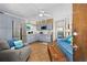 Cozy living room featuring blue sofa, gray chair, and an eat-in kitchen with stainless steel appliances at 1167 Ocean Shore Blvd # 110, Ormond Beach, FL 32176