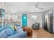 Charming living room with coastal decor, tile flooring, and a bright turquoise door at 1167 Ocean Shore Blvd # 110, Ormond Beach, FL 32176