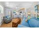 Relaxing living room featuring stylish coastal decor, tile flooring, and a modern kitchen at 1167 Ocean Shore Blvd # 110, Ormond Beach, FL 32176