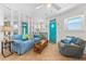 Bright and airy living room featuring coastal decor, tile floors, and comfortable seating at 1167 Ocean Shore Blvd # 110, Ormond Beach, FL 32176