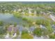 Charming aerial view of lakeside homes in a serene setting with lush trees and calm waters at 1229 Saddleback Ridge Rd, Apopka, FL 32703