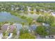 Aerial shot showcasing a cozy neighborhood near a lake, surrounded by mature trees and green spaces at 1229 Saddleback Ridge Rd, Apopka, FL 32703