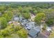 Scenic aerial view of a charming home nestled among mature trees near a serene lake at 1229 Saddleback Ridge Rd, Apopka, FL 32703