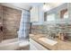 Bathroom featuring a granite countertop, tiled shower, and decorative backsplash at 1229 Saddleback Ridge Rd, Apopka, FL 32703