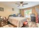 Bedroom with ceiling fan, wood floors, and window bringing in natural light at 1229 Saddleback Ridge Rd, Apopka, FL 32703