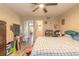 Bedroom featuring wood floors, ceiling fan, and a view into the ensuite bathroom at 1229 Saddleback Ridge Rd, Apopka, FL 32703