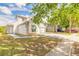 View of the home showing a well-manicured lawn and a long driveway leading to the garage at 1229 Saddleback Ridge Rd, Apopka, FL 32703