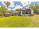 Charming home exterior with a spacious lawn, a screen porch, and a wood deck at 1229 Saddleback Ridge Rd, Apopka, FL 32703