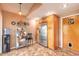 A kitchen featuring stainless steel refrigerator, overhead cabinets, and tile floors at 1229 Saddleback Ridge Rd, Apopka, FL 32703