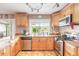 Updated kitchen with tile backsplash, stainless steel appliances, and a bright window overlooking the backyard at 1229 Saddleback Ridge Rd, Apopka, FL 32703