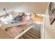 View from stairwell overlooking the living room with a large sofa and open-plan kitchen at 1229 Saddleback Ridge Rd, Apopka, FL 32703