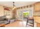 Cozy living area featuring sliding glass doors to the screened patio, open to the kitchen with barstool seating at 1229 Saddleback Ridge Rd, Apopka, FL 32703