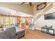Open-concept living room featuring wood floors, a staircase, and a view of the kitchen and screened-in patio at 1229 Saddleback Ridge Rd, Apopka, FL 32703