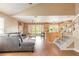 Open floor plan showcasing the living room, kitchen with island seating, and staircase to the second floor at 1229 Saddleback Ridge Rd, Apopka, FL 32703