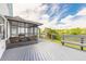 Inviting screened-in porch with wicker furniture and a spacious wood deck overlooking the yard at 1229 Saddleback Ridge Rd, Apopka, FL 32703
