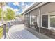Inviting screened-in porch with charming wicker furniture and a spacious, sunny wood deck at 1229 Saddleback Ridge Rd, Apopka, FL 32703
