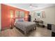 Cozy bedroom with wood-look tile floors and a bright accent wall at 1317 Suwanee Rd, Daytona Beach, FL 32114