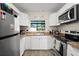 Bright kitchen boasts white cabinets and stainless steel appliances at 1317 Suwanee Rd, Daytona Beach, FL 32114