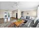 Spacious living room featuring a large sectional couch, wood-look floors and sliding glass doors to outside at 1317 Suwanee Rd, Daytona Beach, FL 32114