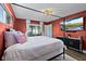Stylish bedroom with a four-poster bed, modern furnishings, and lots of natural light from a large window at 1317 Suwanee Rd, Daytona Beach, FL 32114