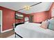 Serene bedroom with a comfortable four-poster bed, modern decor, and tile floors at 1317 Suwanee Rd, Daytona Beach, FL 32114