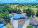 Aerial view of property showing home, garage and landscaping, with golf course nearby at 1371 Merrifield Ct, Deltona, FL 32725