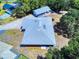 Aerial view of property showing home, detached garage, and surrounding landscape at 1371 Merrifield Ct, Deltona, FL 32725