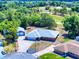 Aerial view of the property showcasing the house, garage, and proximity to a golf course at 1371 Merrifield Ct, Deltona, FL 32725