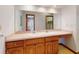 Bathroom features double sinks, vanity and large mirror reflecting shower and walk-in closet at 1371 Merrifield Ct, Deltona, FL 32725