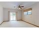 Bedroom features carpeting, ceiling fan, sliding glass door to patio and window at 1371 Merrifield Ct, Deltona, FL 32725