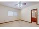 Bedroom featuring carpet, ceiling fan and a view to the bathroom vanity at 1371 Merrifield Ct, Deltona, FL 32725
