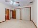 Bedroom featuring three closets, ceiling fan and a view to the bathroom at 1371 Merrifield Ct, Deltona, FL 32725