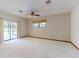 Bedroom features carpeting, ceiling fan, sliding glass door to patio and window at 1371 Merrifield Ct, Deltona, FL 32725