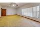 Bedroom with neutral paint, carpet, a window and a ceiling fan at 1371 Merrifield Ct, Deltona, FL 32725