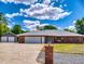 Charming single-story brick home with a long driveway and detached two-car garage at 1371 Merrifield Ct, Deltona, FL 32725