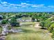 Scenic aerial view of a well-maintained golf course surrounded by lush greenery, sand traps, and clear blue skies at 1371 Merrifield Ct, Deltona, FL 32725