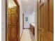 Hallway featuring wood trim, tile flooring, and a vanity with double sinks in the background at 1371 Merrifield Ct, Deltona, FL 32725