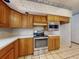 A renovated kitchen featuring stainless steel appliances, wooden cabinets and neutral countertops at 1371 Merrifield Ct, Deltona, FL 32725