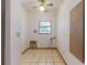 Bright laundry room features tile flooring, ceiling fan, and a window at 1371 Merrifield Ct, Deltona, FL 32725