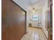 Laundry room featuring tile floors, ceiling fan, a window and closet space at 1371 Merrifield Ct, Deltona, FL 32725