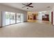 Large living room offers an open concept layout with access to the screened-in patio at 1371 Merrifield Ct, Deltona, FL 32725