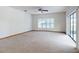 Spacious living room with carpet, ceiling fan, and sliding glass doors for natural light at 1371 Merrifield Ct, Deltona, FL 32725