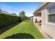 A well-maintained yard has a covered patio, lush lawn, and manicured privacy hedge at 1374 Red Clover Ln, Deland, FL 32724